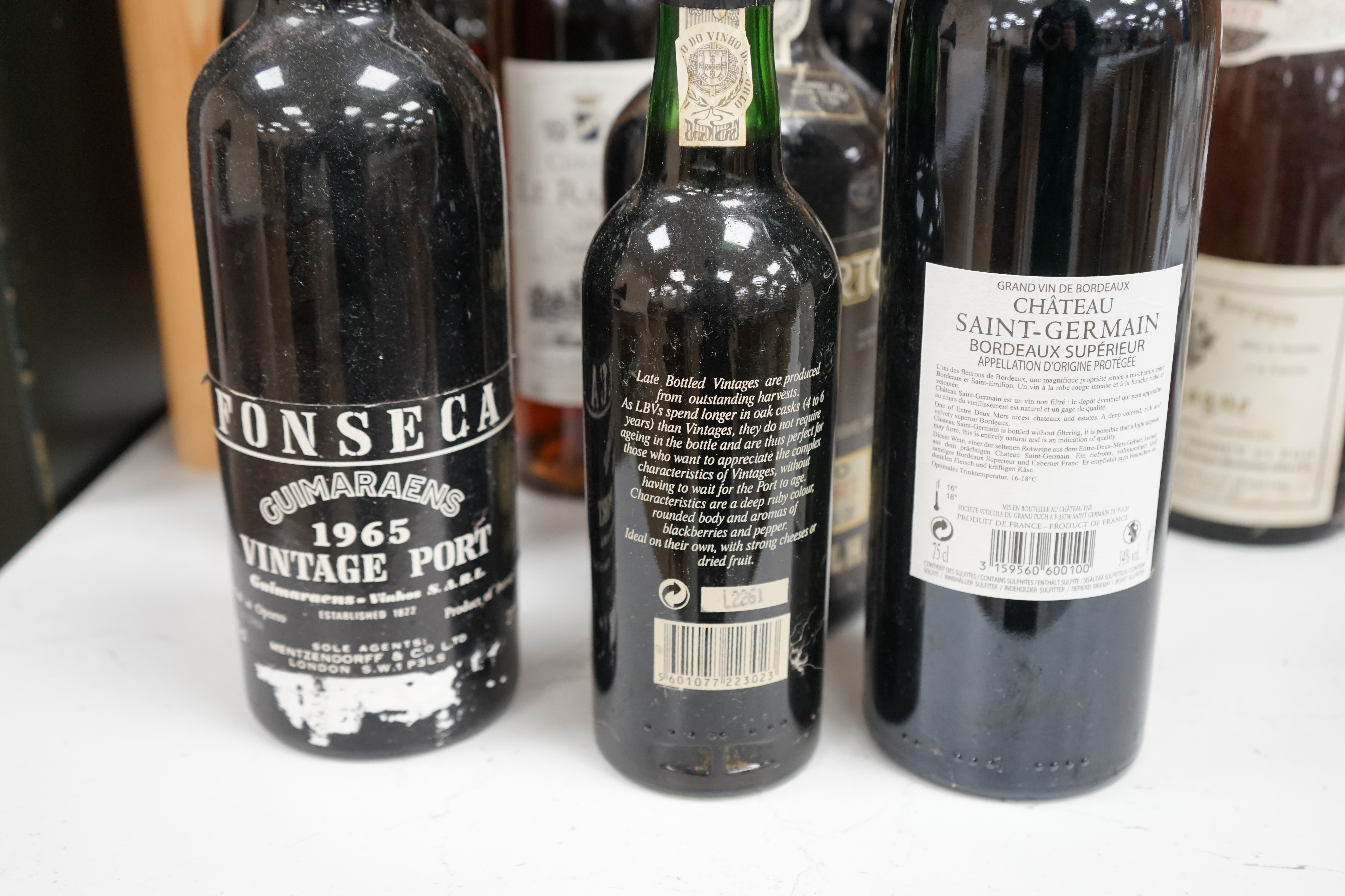 Seven bottles of mixed wines including St Emilion, Sauternes, Bordeaux, together with five bottles of mixed ports including Dow’s and two bottles of Fonseca port and a bottle of Calvados. Condition - unknown storage.